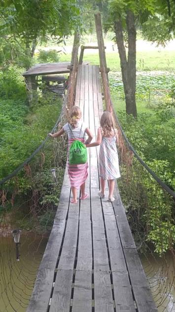 girls swinging bridge